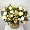 A luxurious holiday arrangement featuring creamy white roses and lisianthus paired with