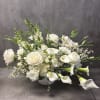 A beautiful,  overflowing, all white arrangement. Filled with a variety of
