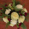Beautiful holiday bouquet mix of fragrant evergreens, roses, carnations, in a round