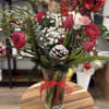 A stunning Christmas arrangement featuring rich red tulips, premium carnations, soft white