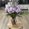 A graceful and romantic display featuring lavender roses arranged with delicate baby&rsquo;s