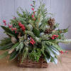 A beautiful assortment of premium Christmas greenery designed in a basket and