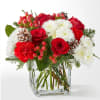 A delicate balance of red and white florals accented with seasonal greens