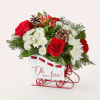 Our Snowfall Sleigh Bouquet is a charming holiday centerpiece featuring lush red