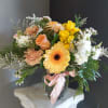 A beautiful floral arrangement with seasonal fresh flowers in a vase. 