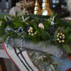 Enjoy this timeless tablescape arrangement in a birch planter mixed with evergreens