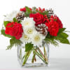 A delicate balance of red and white florals accented with seasonal greens