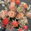 Dreamy peach roses and textured garden blooms blend into a soft, glowing