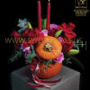 The Pumpkin Candlelight Floral Arrangement by SweetPetals captures the cozy spirit of