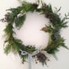 18 inch diameter wreath, handmade with Christmas greens, thistle and berries. 
