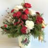 This metal tin is filled with beautiful white roses and red carnations