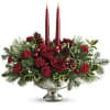 Deck the halls with this elegant centerpiece of rich red roses and