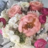 An abundant blend of soft pinks and creamy whites, featuring sculptural blooms