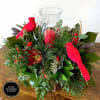 Round-style holiday centerpiece with red candle in candle holder and cardinal couple