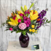 A delightfully vibrant mix of blooms that are presented in a purple
