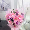 This arrangement is soft, feminine, and quietly celebratory. A delicate harmony of