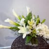 A fresh, crisp design of white calla lilies, hydrangea, asiatic lilies and