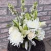A lush arrangement all dressed in white. Designed in a glass rectangular