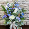 A serene holiday arrangement featuring a harmonious blend of soft blues and