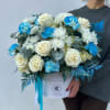 This flower arrangement features a stunning combination of white roses, white chrysanthemums
