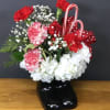 Carnations and candy canes in a cute Santa Boot Ceramic Container.