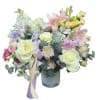 A dreamy pastel mix of ivory roses, blush lilies, buttery spray roses
