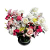 A luxe low-vase arrangement featuring white cymbidium orchids, ivory roses, and a