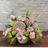 Basket filled with pastel florals and faux candy extras 