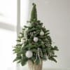 A sophisticated tabletop tree designed with fresh premium evergreens and styled in