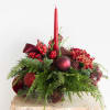 A lush holiday centerpiece designed in rich crimson tones with a seasonal