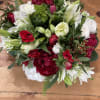 Low and lush white &amp; red winter arrangement with seasonal accents and