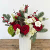 Elegant and festive, Holiday Aura is a timeless seasonal arrangement designed to
