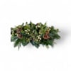 Pure and simple winter elegance&mdash;fresh greens, white berries, and pine cones arranged