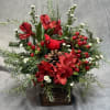 Inspired by classic Christmas colors, this arrangement features vibrant reds, winter foliage