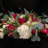 Celebrate the timeless joy of Christmas, with this beautiful warm flower arrangement