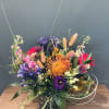 A bright mix of fun flowers, including pin cushion protea, agapanthus, allium