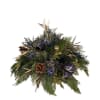 A striking holiday centerpiece featuring lush winter greens, pinecones, and rich blue