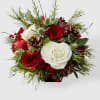 A festive seasonal arrangement featuring a mix of rich red and creamy