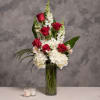 red roses, hydrangea, snapdragon, and tropical leaves  