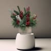 This arrangement comes in a clay vase filled with holiday greenery, artificial