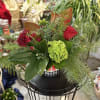 Filled with evergreens, magnolia, red roses and mums, and green hydrangea and