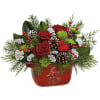 This holiday bouquet includes red roses, miniature white carnations, green cushion spray