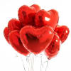 A vibrant cluster of glossy red, heart-shaped foil balloons gathered together in