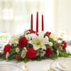 3 Red Candles in a long low centerpiece, winter greens, white lilies