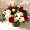 Seasonal white and red flowers with holiday greens. Perfect for the holiday