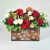 A festive holiday centerpiece featuring rich red and soft ivory roses accented