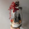 This adorable vintage mason jar has captured Rudolph the Red-Nosed Reindeer amongst