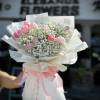 A wrapped bouquet of flowers is a beautifully arranged collection of blooms