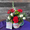 This charming floral arrangement is designed in a keepsake mug and paired