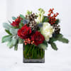 Inspired by the quiet beauty of winter gatherings, the Hollybrook arrangement pairs